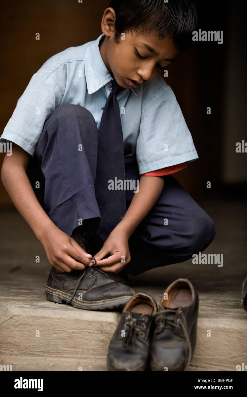 Boy putting shoes on shoe hires stock photography and images Alamy