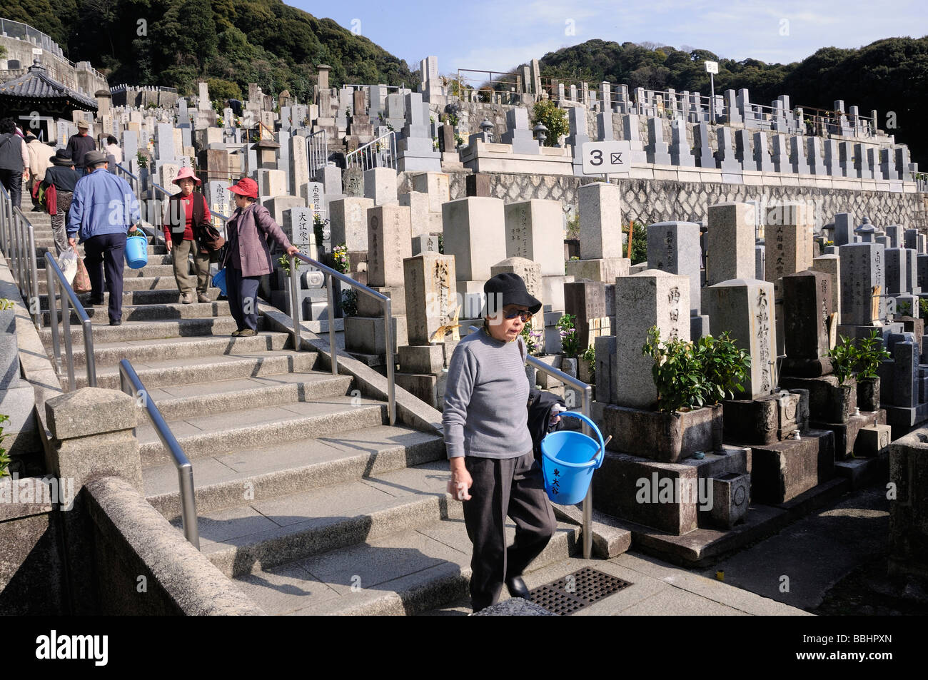 Visit to the deceased ancestors in the cemetery at Hanamatsuri, flower festival, Buddha's birthday celebration, the temple fest Stock Photo