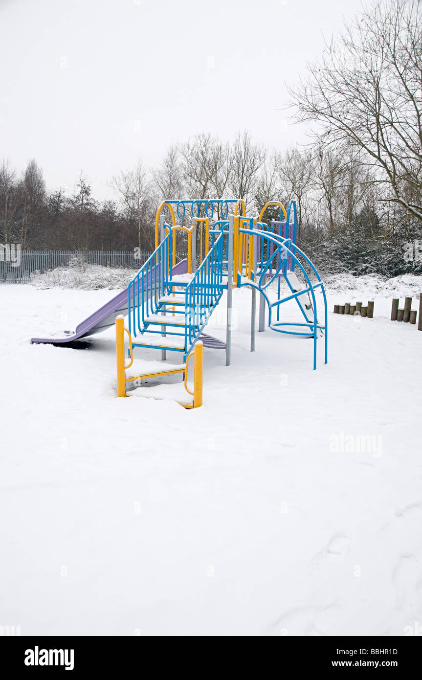 a childrens climbing frame in a park in the snow Stock Photo