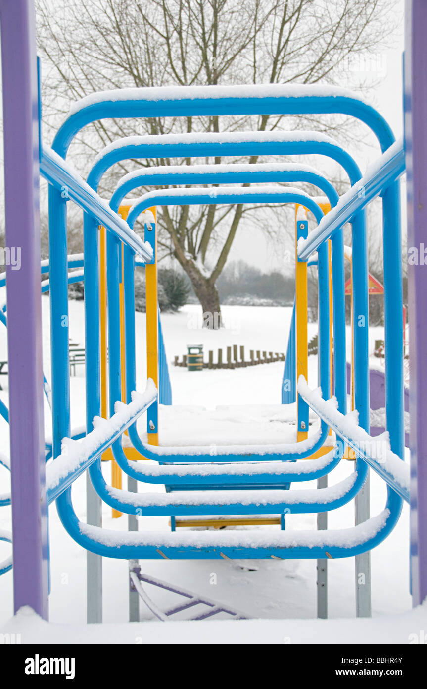 a childrens climbing frame in a park in the snow Stock Photo