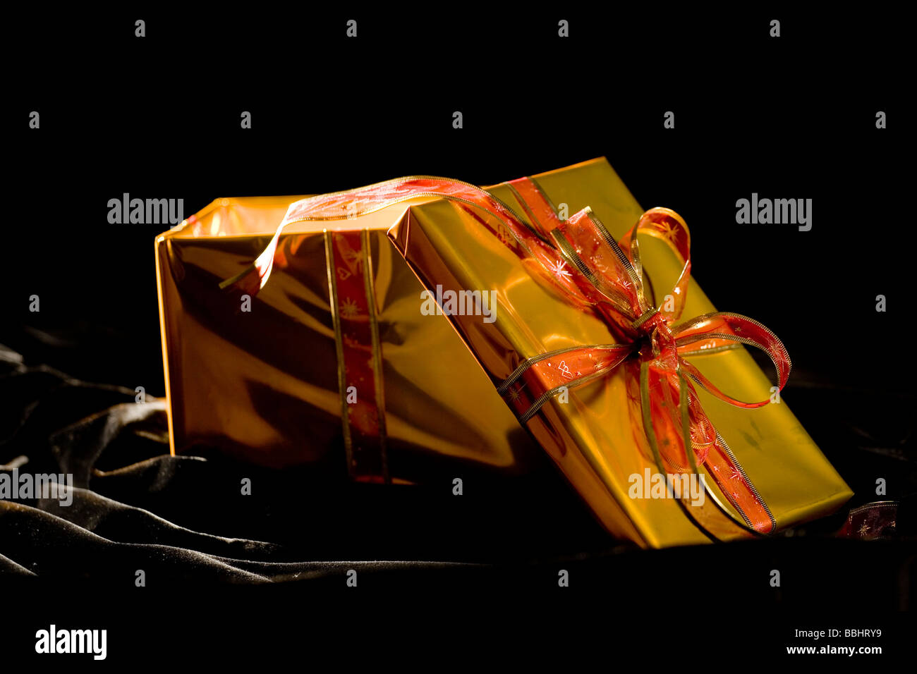 present  in glod box with bow Stock Photo