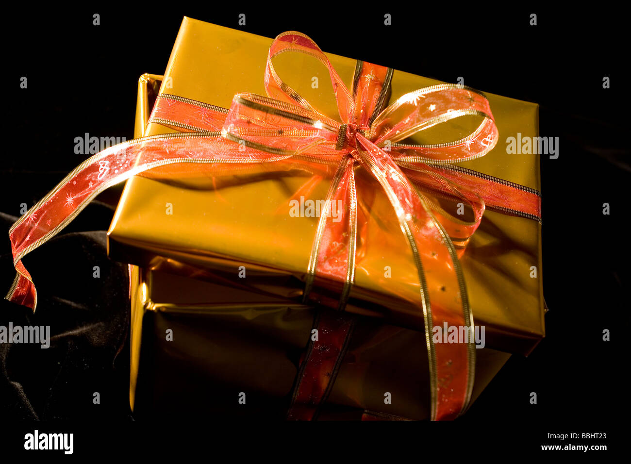 present  in glod box with bow Stock Photo