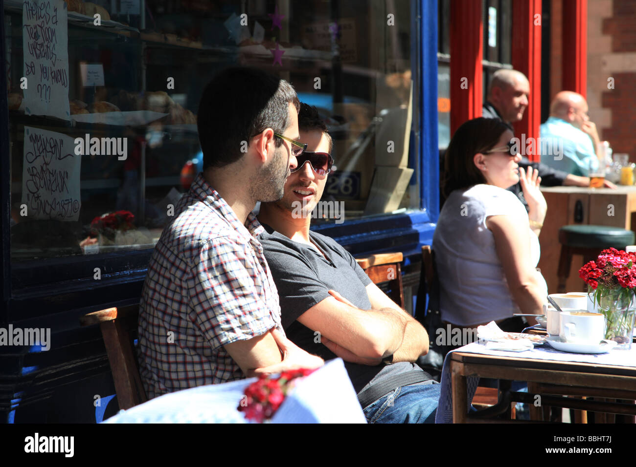 Two men chat outside the Maison Bertaux patisserie in Greek Street Soho London England Stock Photo