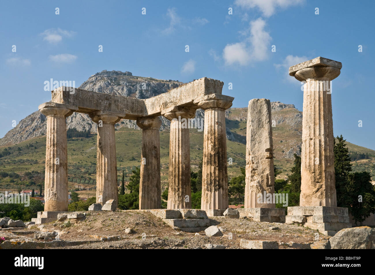 Looking across the 5th cen BC site of the Temple of Apollo at Ancient Corinth, Peloponnese, Greece Stock Photo
