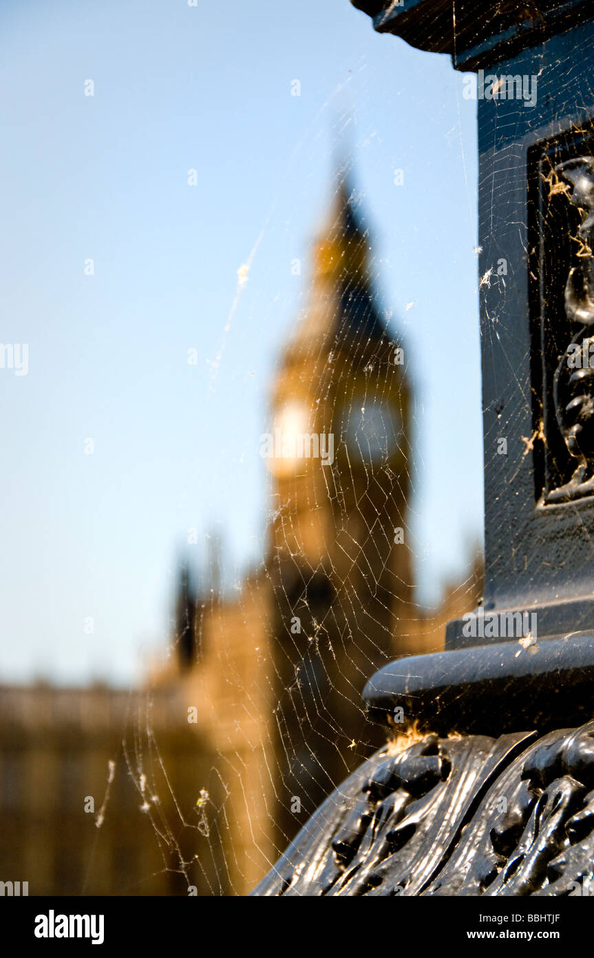 Concept image: Houses of Parliament with spiders web in foreground Old rules and laws in need of a clean fresh change London UK Stock Photo