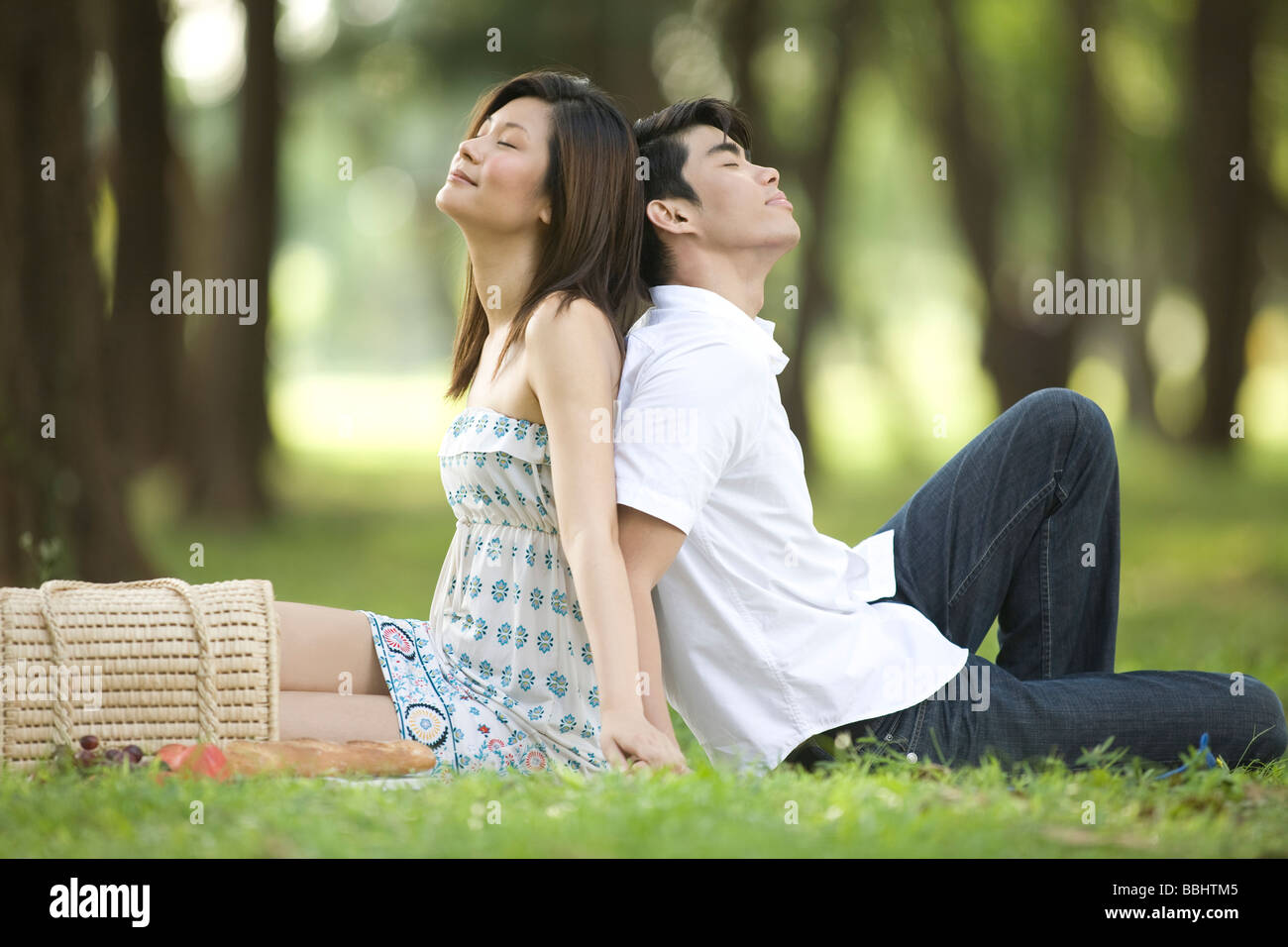 Young couple having picnic in the park Stock Photo - Alamy