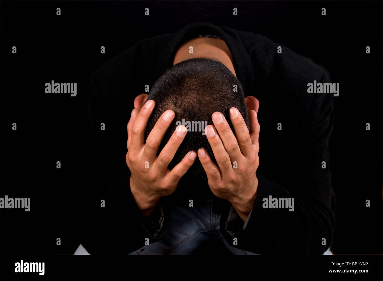 Depressed man holding his head in his hands Stock Photo - Alamy