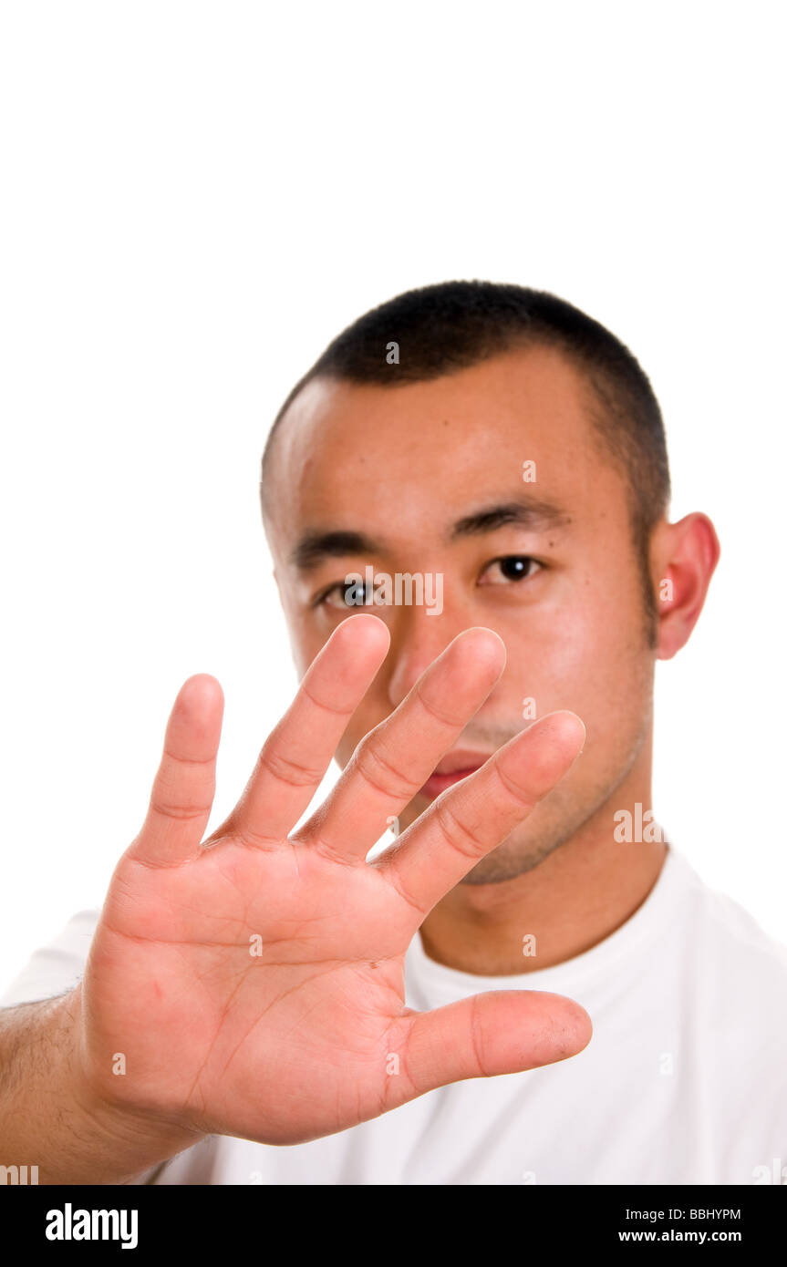 Annoyed expression of a man using the stop hand signal Stock Photo