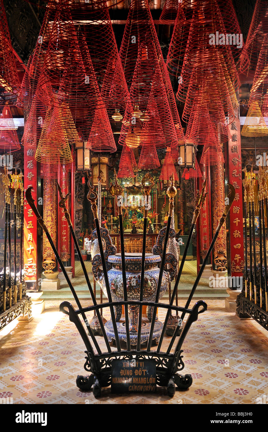 Historic spears and red incense spirals at Phuoc An Hoi Quan Pagoda, Ho Chi Minh City, Saigon, Vietnam, Southeast Asia Stock Photo