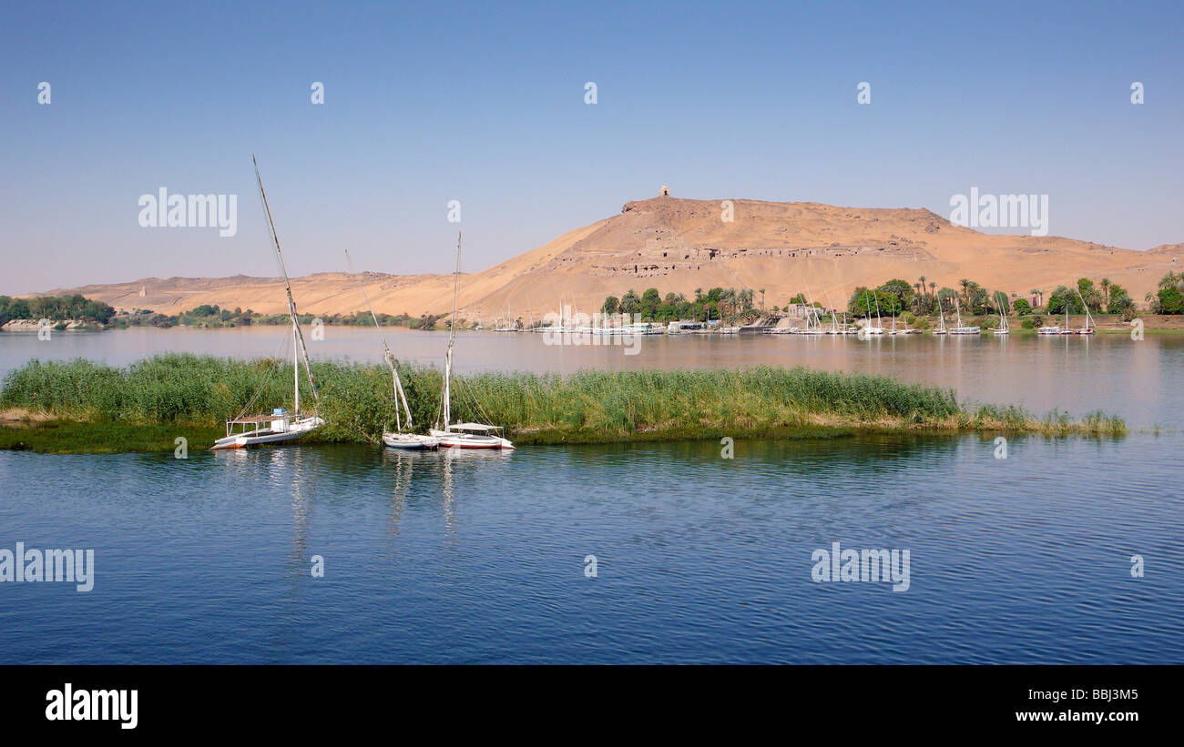 Nile at Aswan, in the back rock tombs, Egypt, Africa Stock Photo