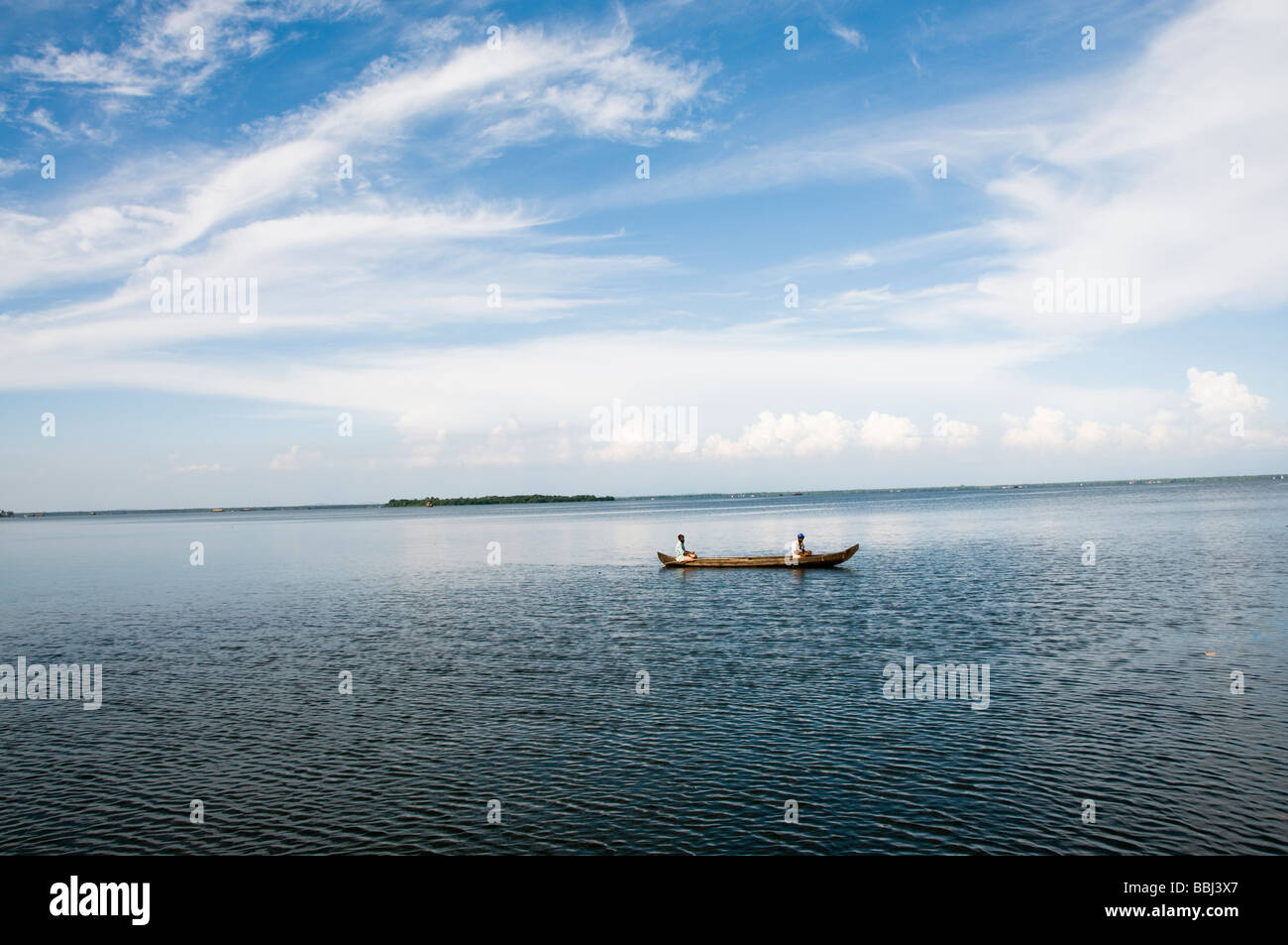 Indian fisherman in rowing boat fishing on lake, backwaters kerala Stock Photo