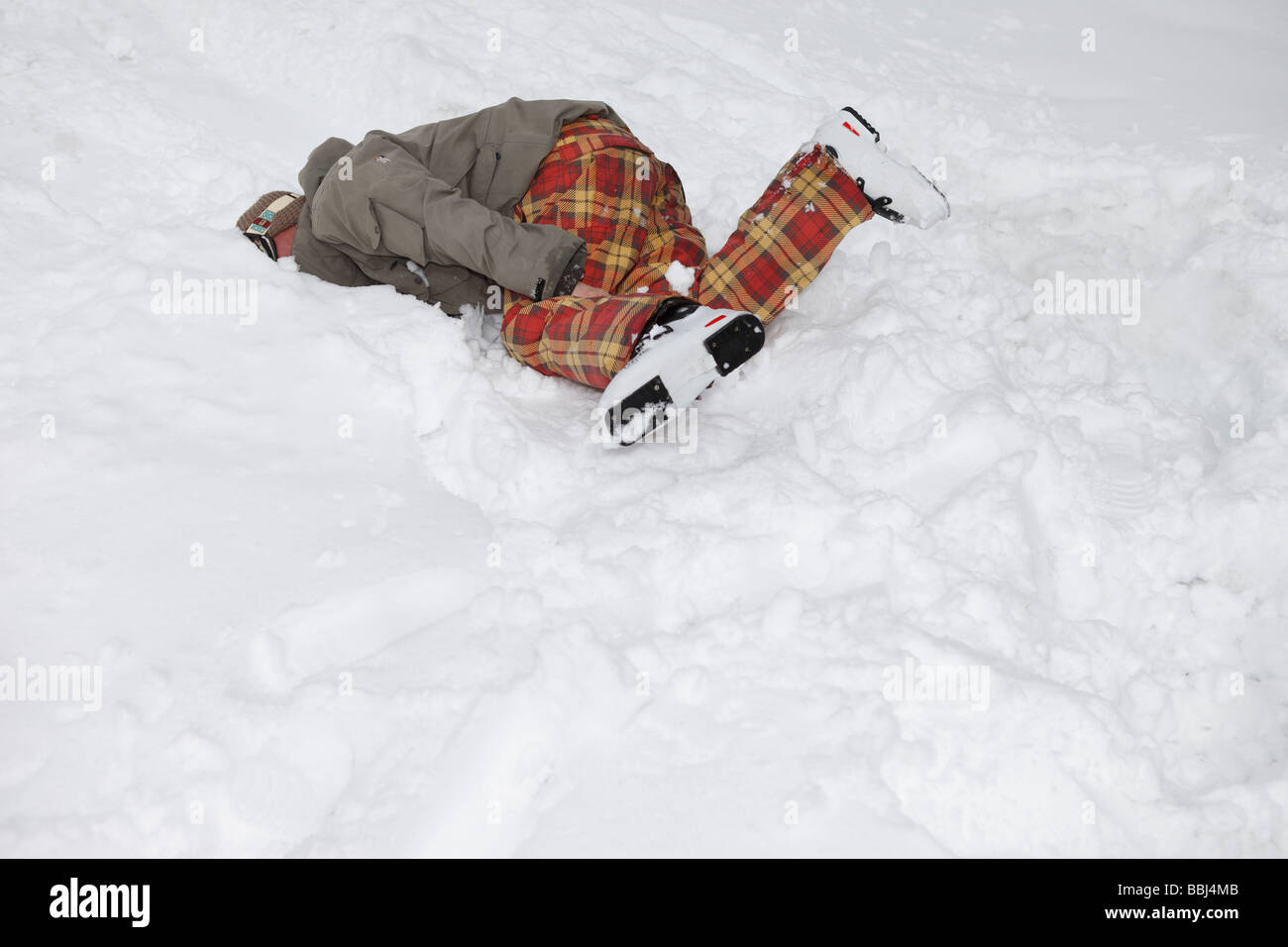 Skier crashes into the fresh snow after jumping off a cliff in the ski resort of Les Deux Alps, The Alps, France Stock Photo