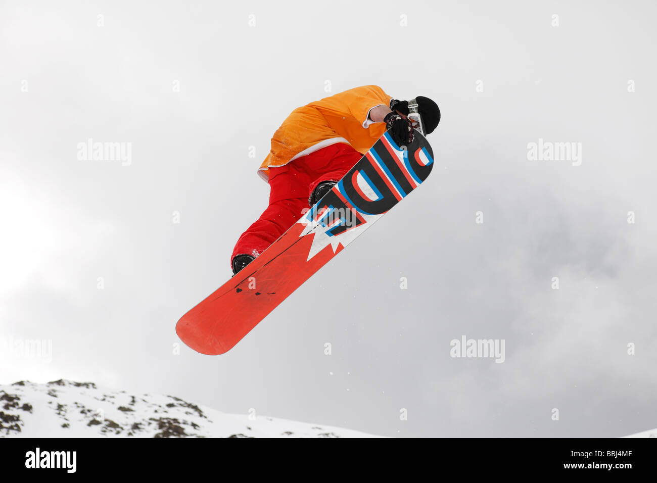 Snowboarder makes a jump in the ski resort of Les Deux Alps, (in Isère), part of the Grande Galaxie Ski Area, The Alps, France Stock Photo