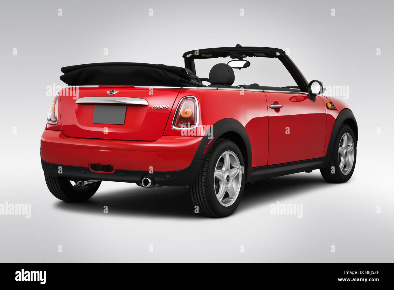 A Red Mini Cooper wth a Union Jack Roof by John Cooper version of the mini  parked on a cobbled street in Huddersfield Stock Photo - Alamy