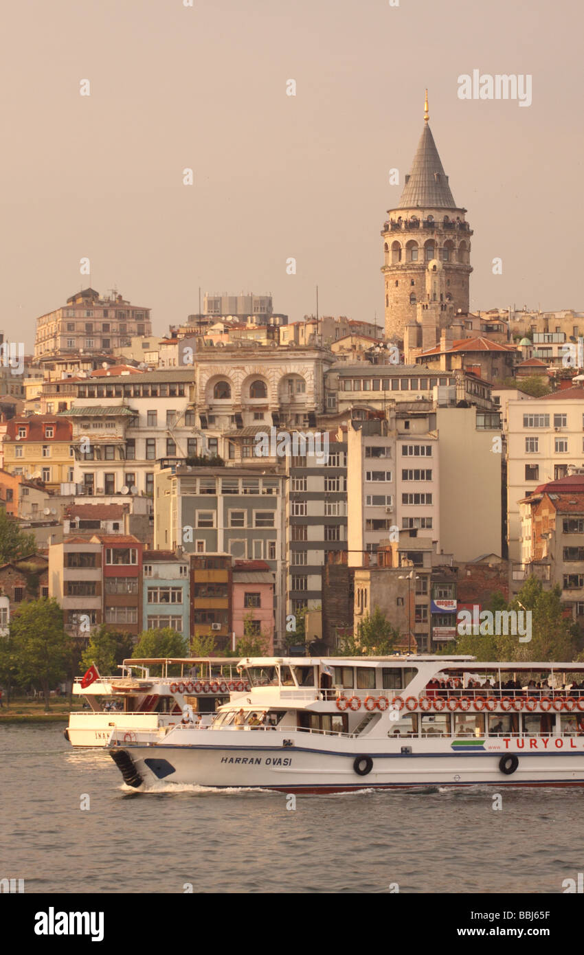 Istanbul Turkey ferry boat on the Golden Horn passing the Galata Tower and the Beyoglu district Stock Photo