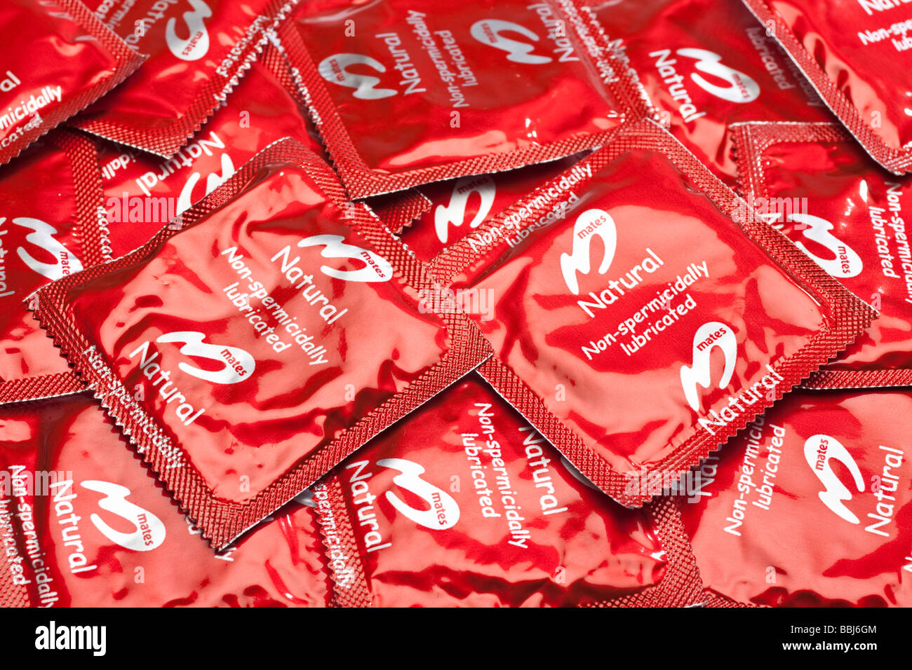 Condoms in red foil packets close up Stock Photo