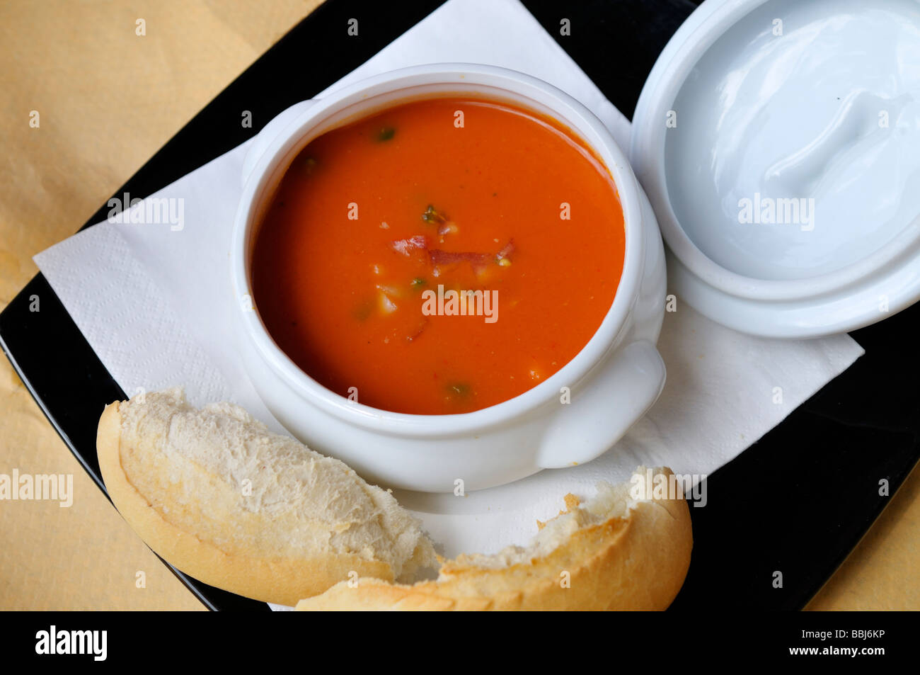 Bowl of tomato and vegetable soup with bread Stock Photo