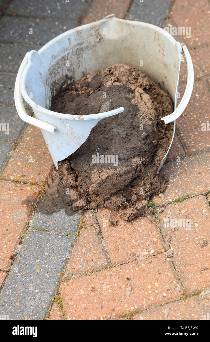 A broken bucket of mud and sand Stock Photo Alamy