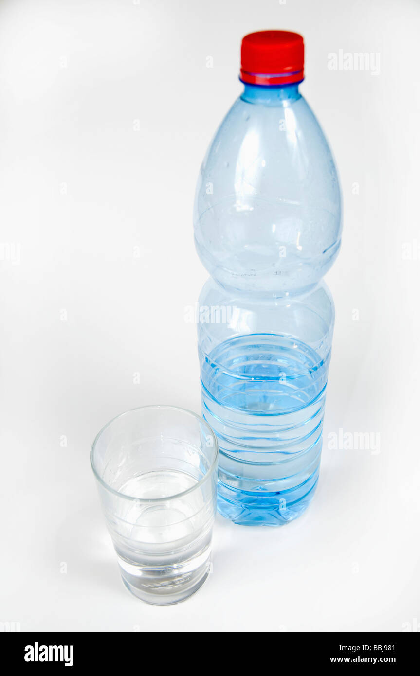 Cutout of a Plastic Bottle and glass of Mineral Water on white background Stock Photo