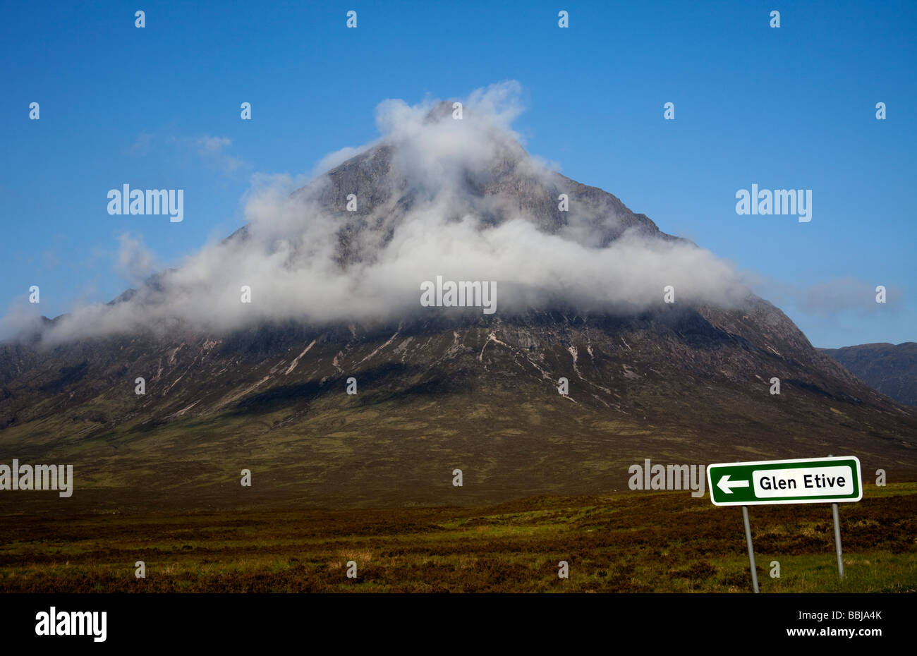 Buachaille Etive Mor mountain shrouded in mist with Glen Etive signpost in foreground, Lochaber Scotland, UK, Europe Stock Photo