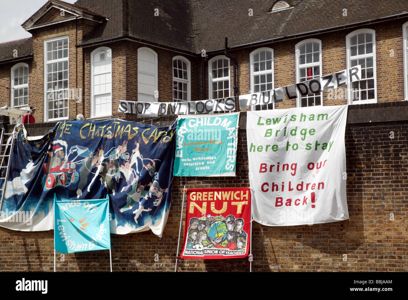 Banners against the demolition of Lewisham Bridge Primary School  during a roof-top protest and occupation of the school Stock Photo