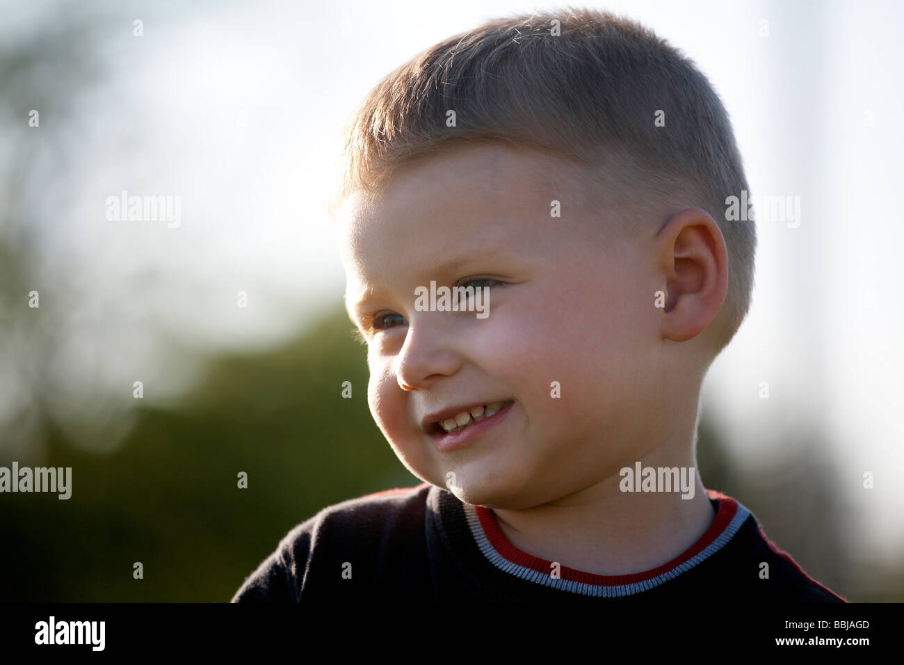 Portrait of boy smiling outdoors Stock Photo - Alamy
