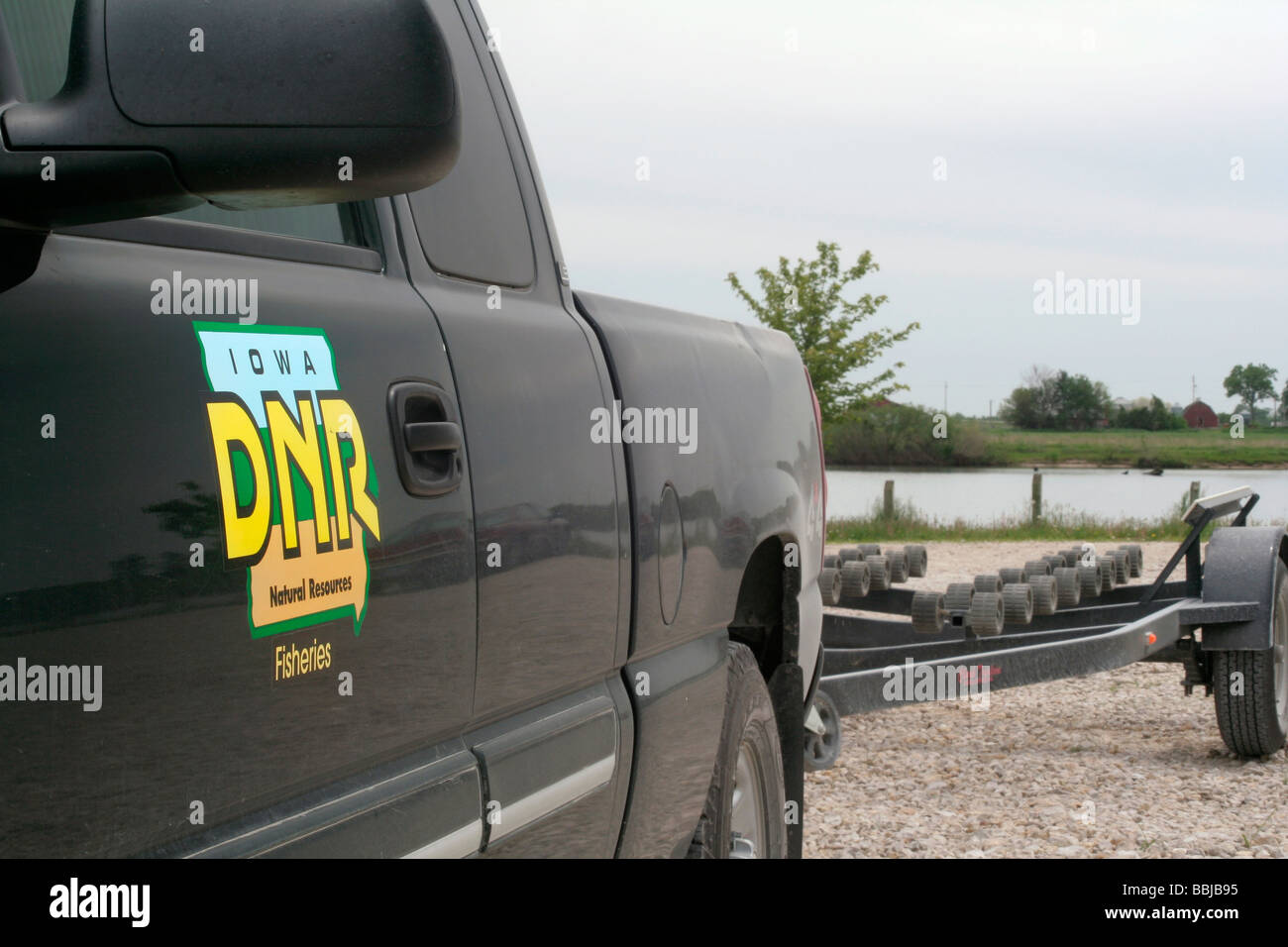 Iowa DNR Fisheries pickup truck and boat trailer at lake where fish