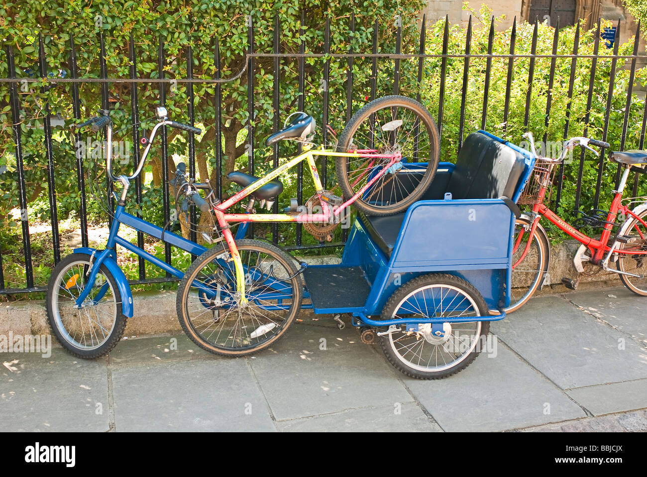 Bicycles and tricycle parked on public path in Oxford UK Stock Photo