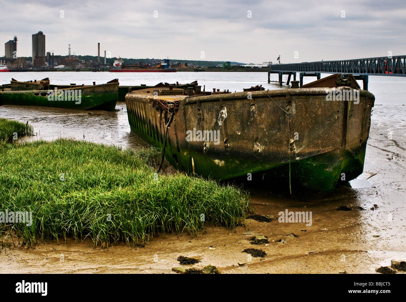 The remains of old concrete barges beached on the Essex foreshore of the Thames. Stock Photo