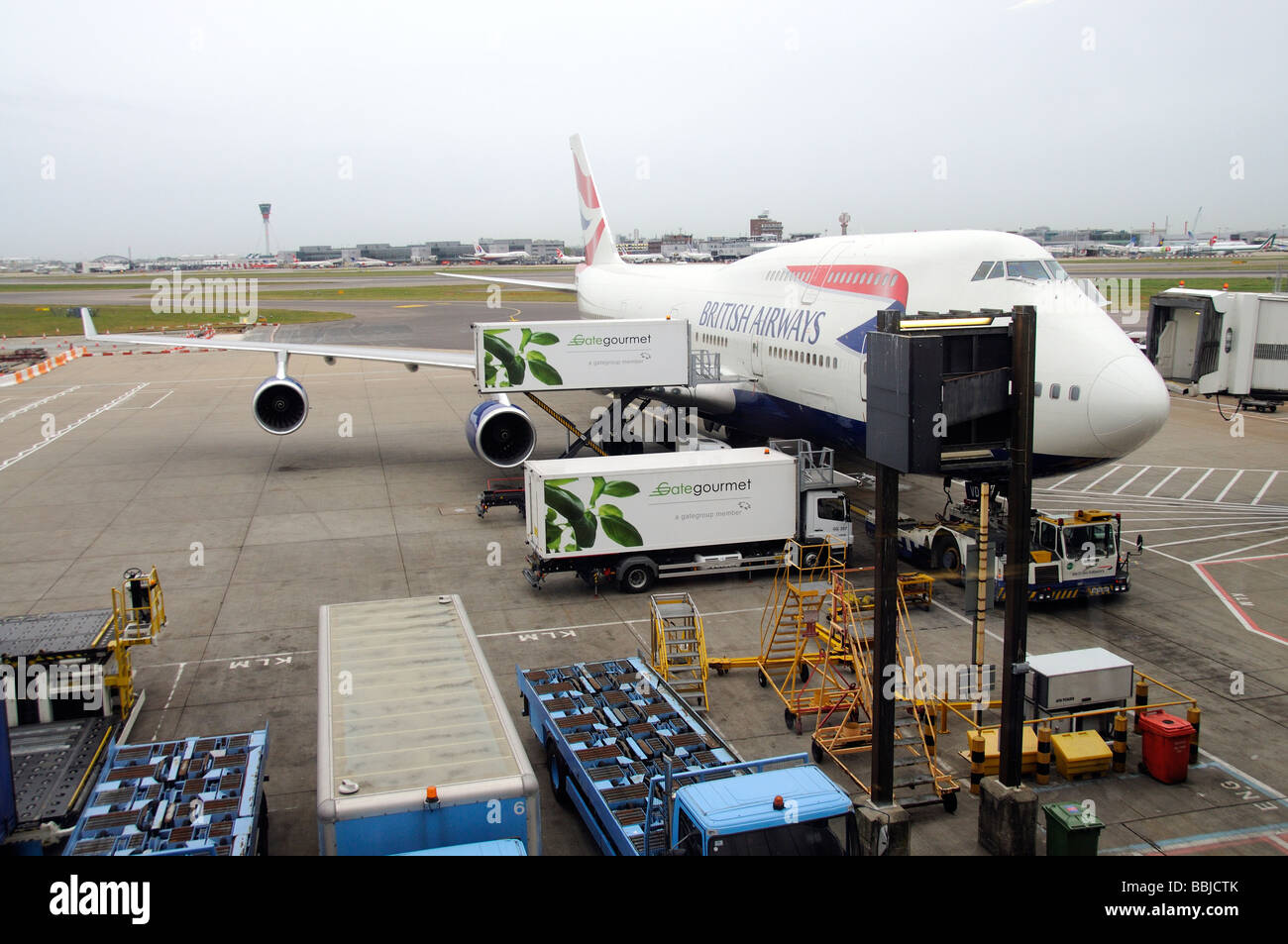 Gategourmet catering supplier trucks loading a BA 747 jet aircraft at London Heathrow airport Stock Photo