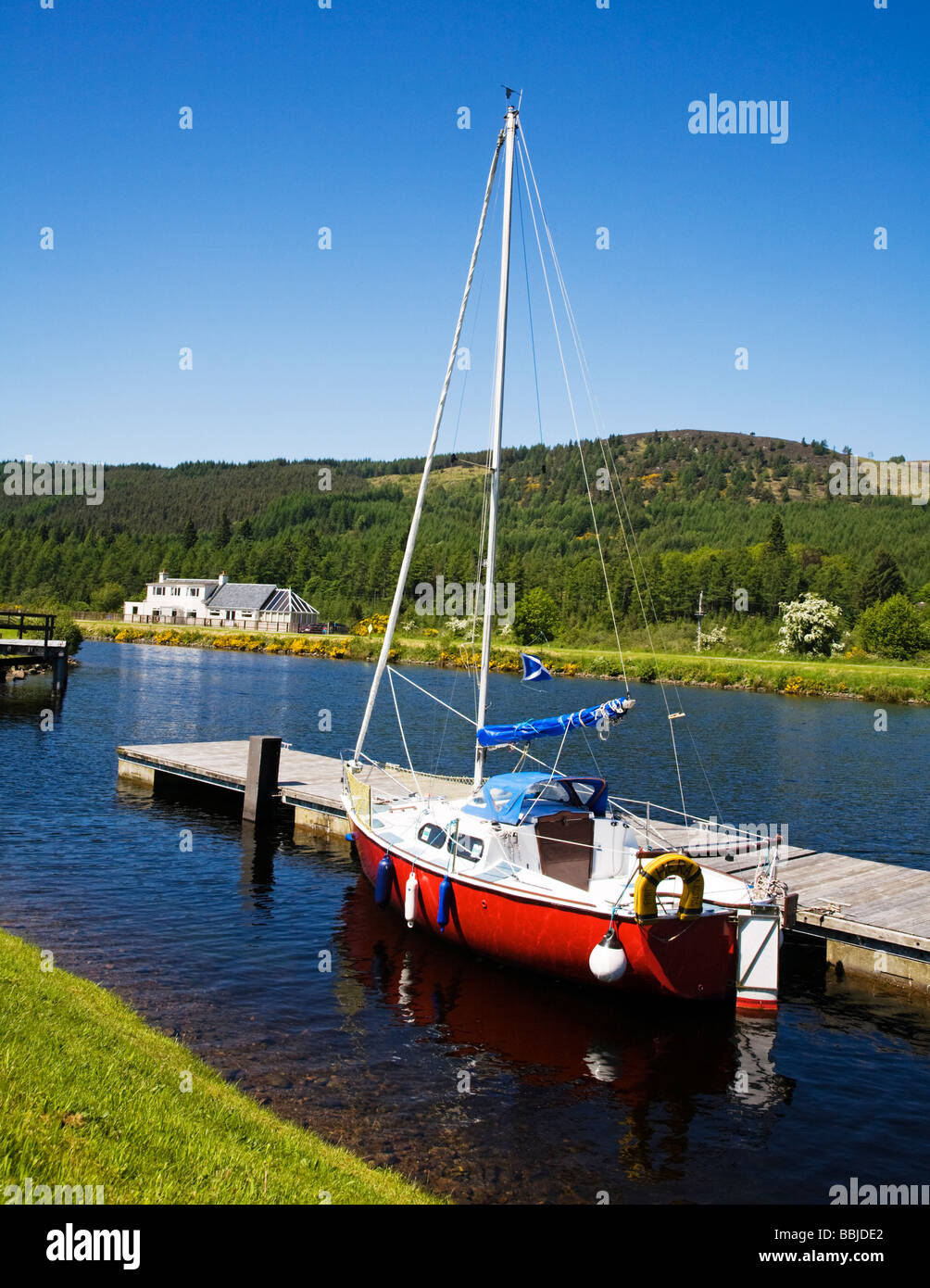 A red yacht moored on the Caledonian Canal at Fort Augustus Highland Region Scotland Stock Photo