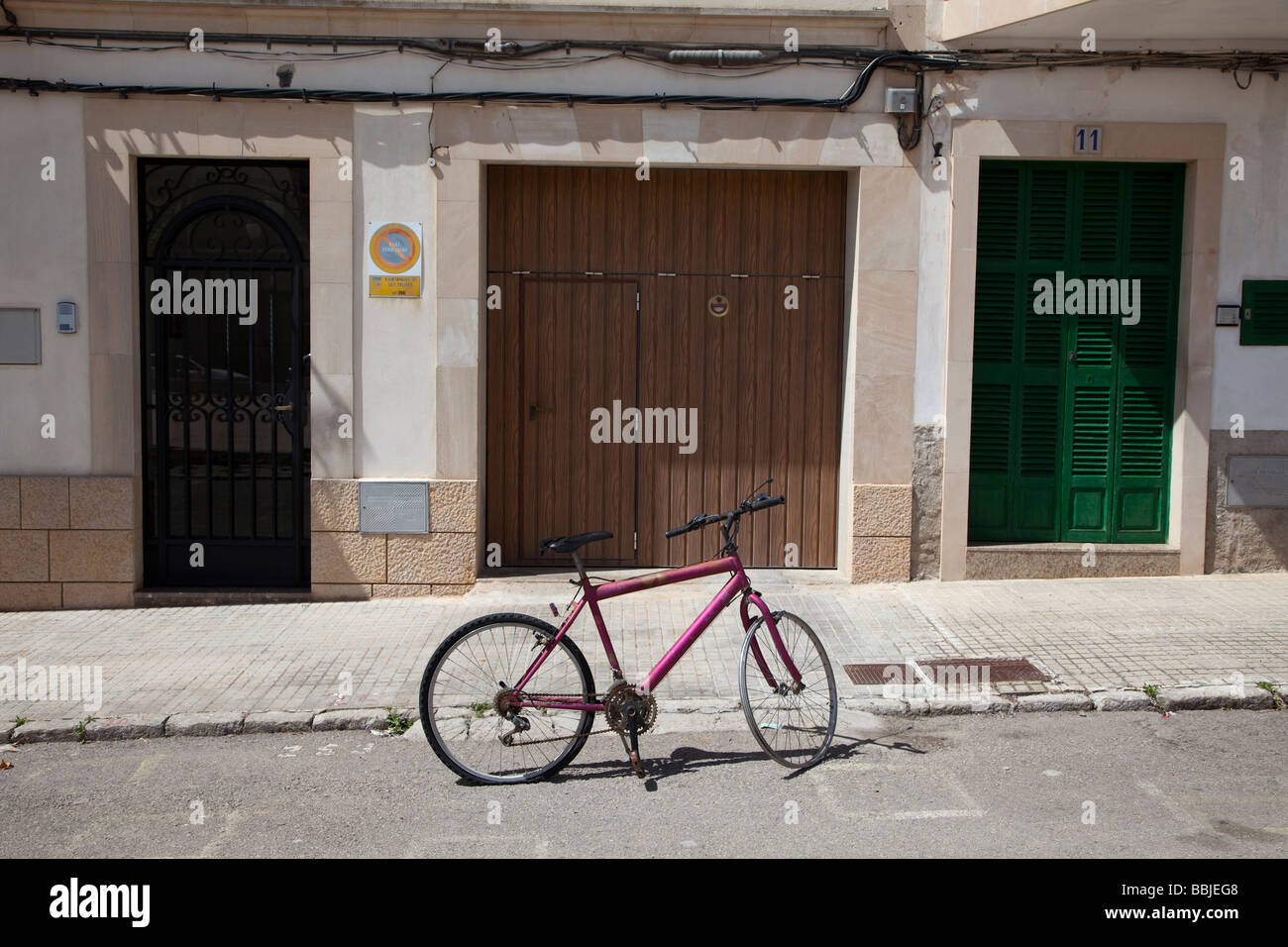 Damaged bicycle with no tyre in street Mallorca Spain Stock Photo