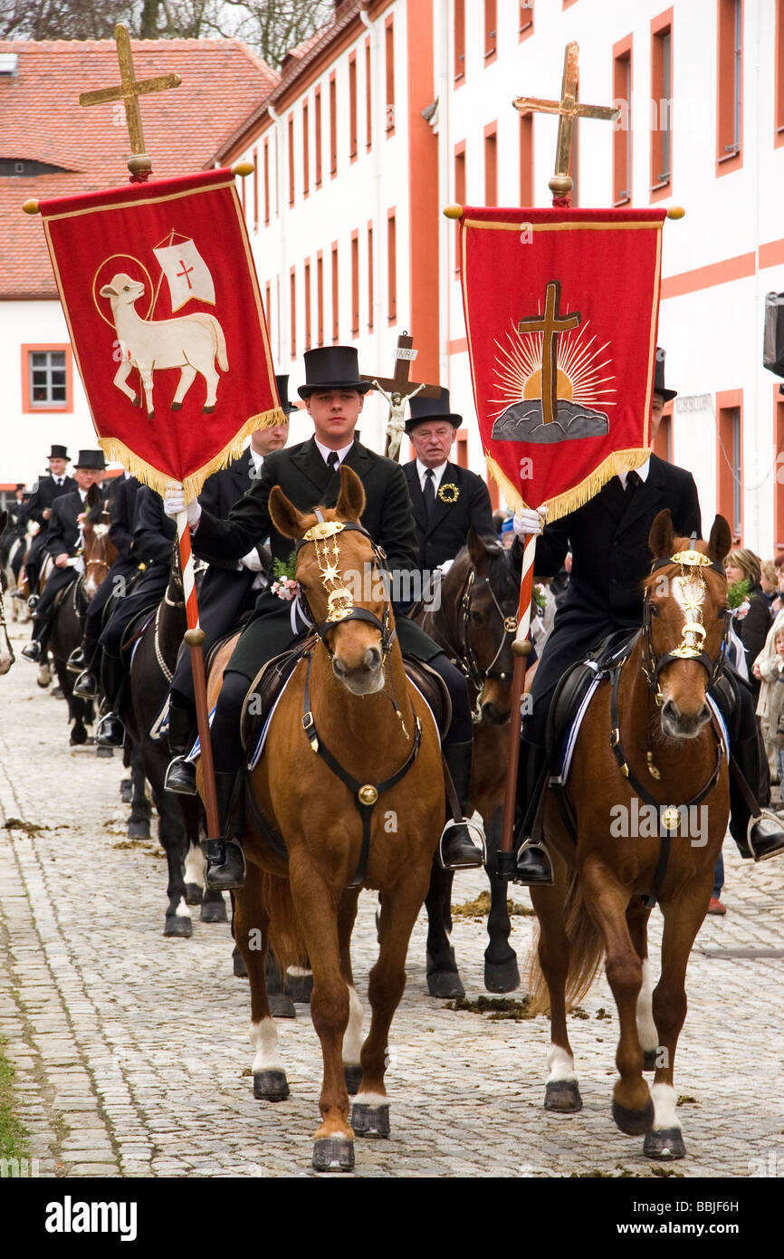 Men from the Sorben population of eastern Germany,  a Slavic minority, ride horses and sign hymns during traditional Osterreiten Stock Photo