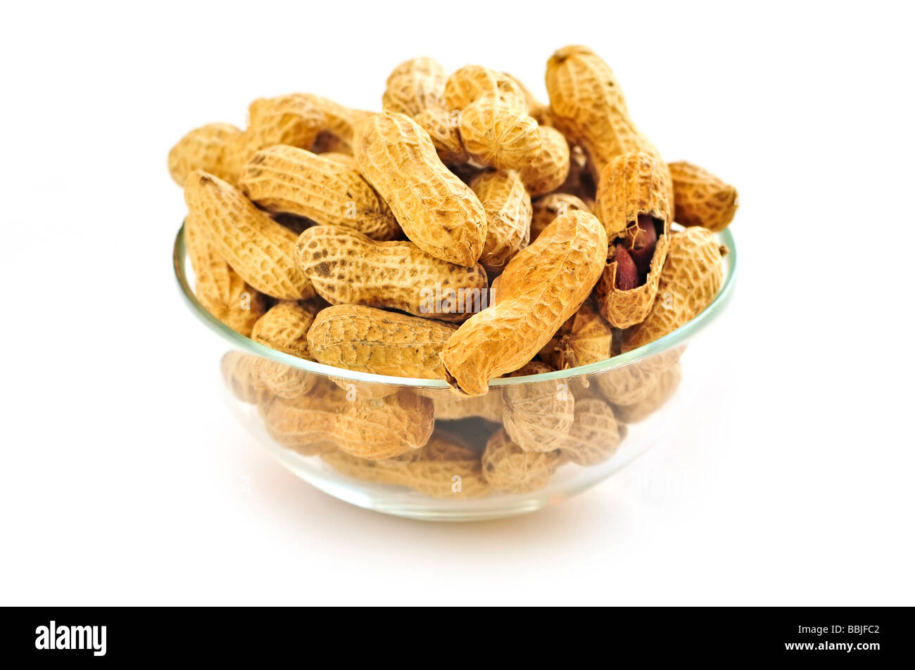 Closeup on bowl of peanuts with shells Stock Photo
