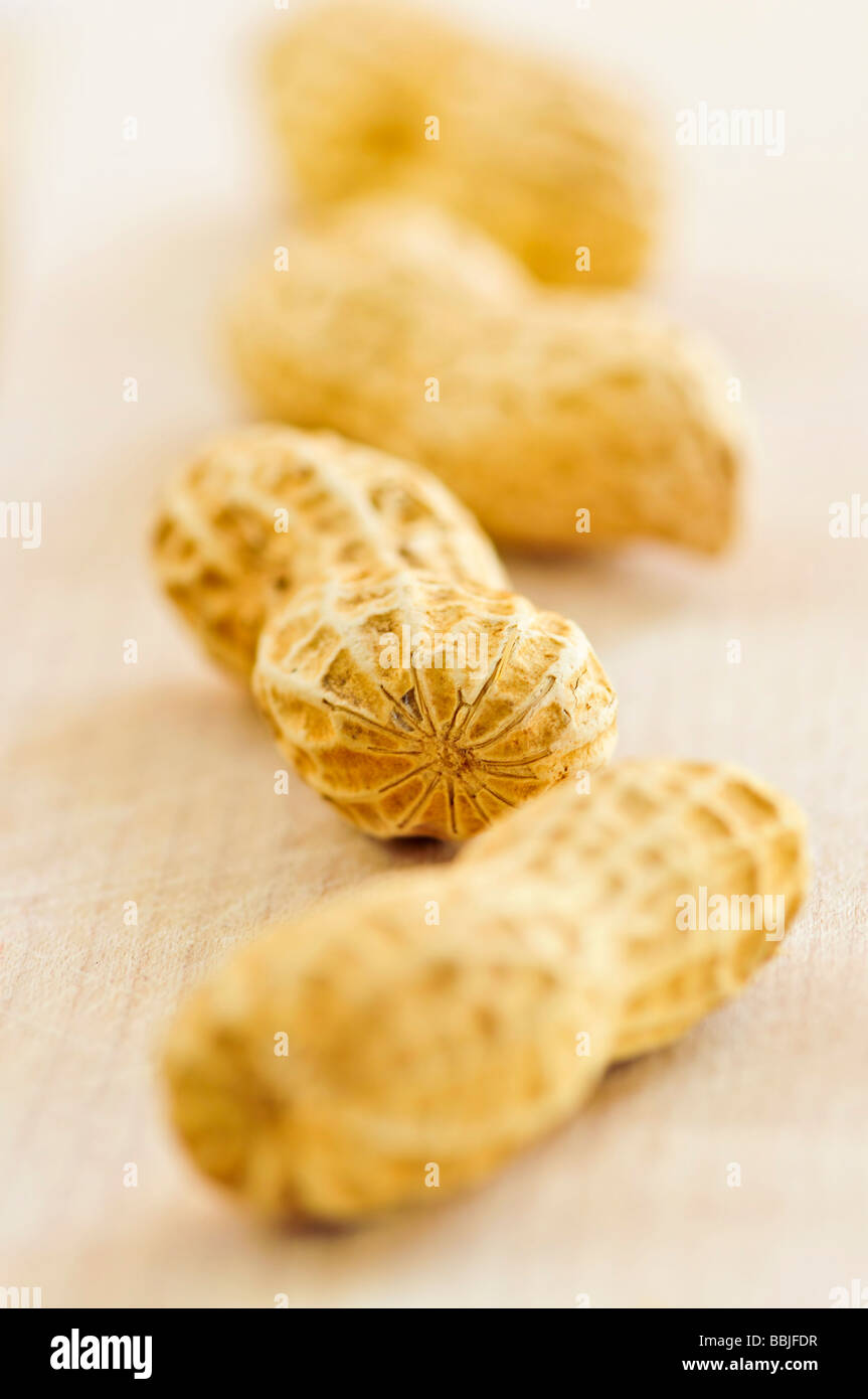 Closeup of peanuts with shells in a row Stock Photo Alamy