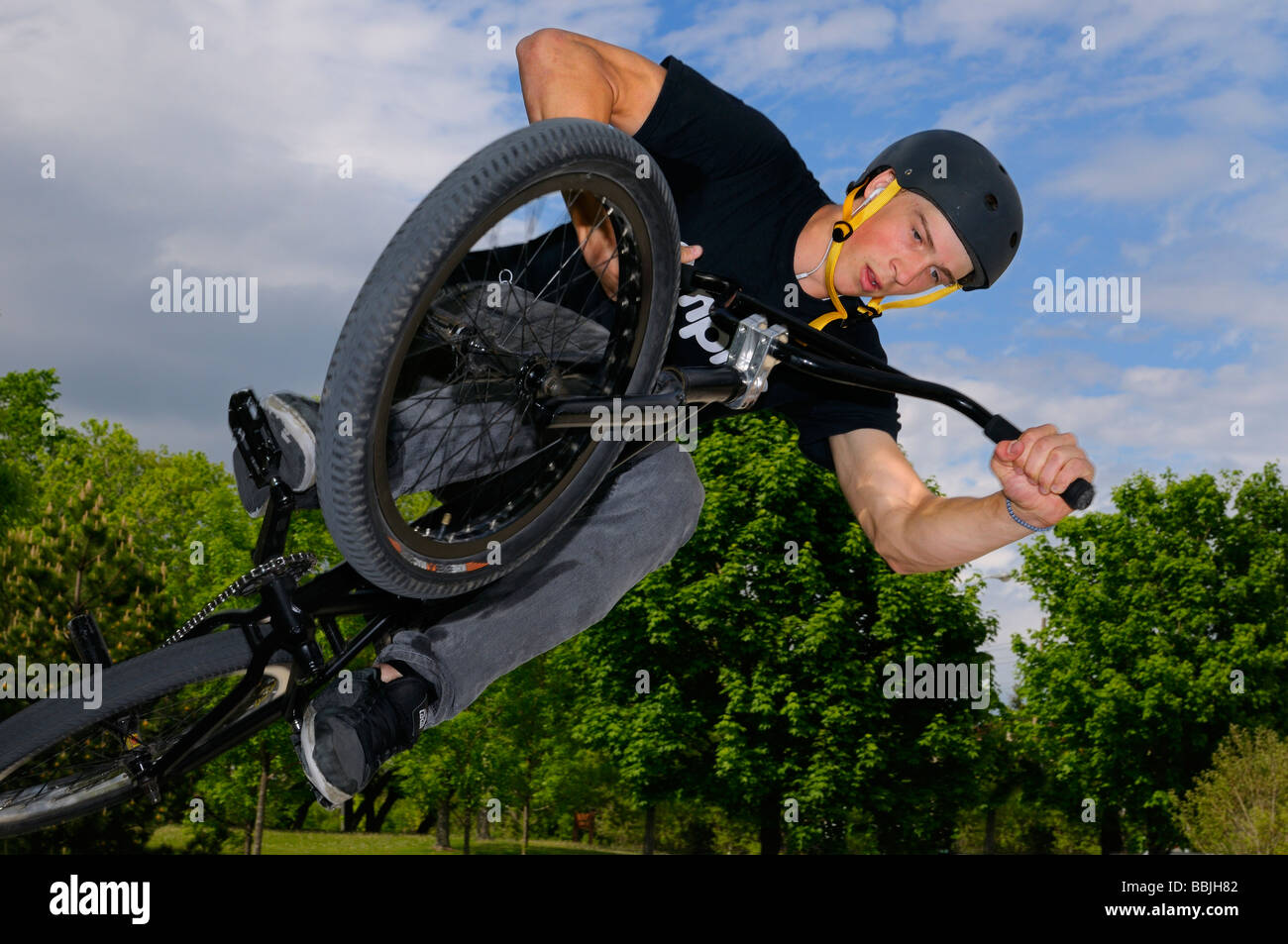 Airborne BMX bike rider in an Air Out Tabletop in an outdoor city