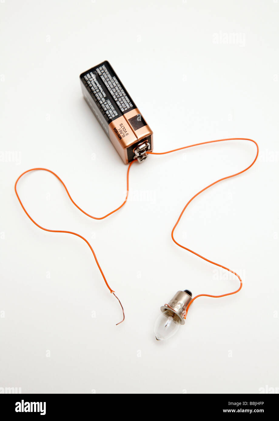 battery and bulb circuit with one wire not attached to bulb Stock Photo