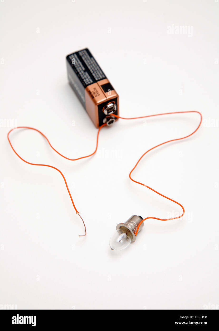 battery and bulb circuit with one wire not attached to bulb Stock Photo