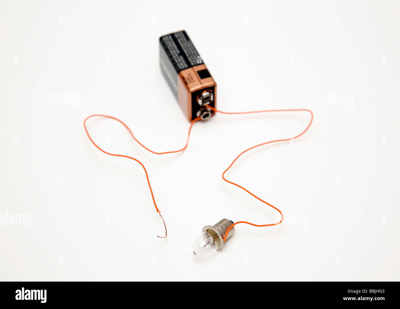 battery and bulb circuit with one wire not attached to bulb Stock Photo
