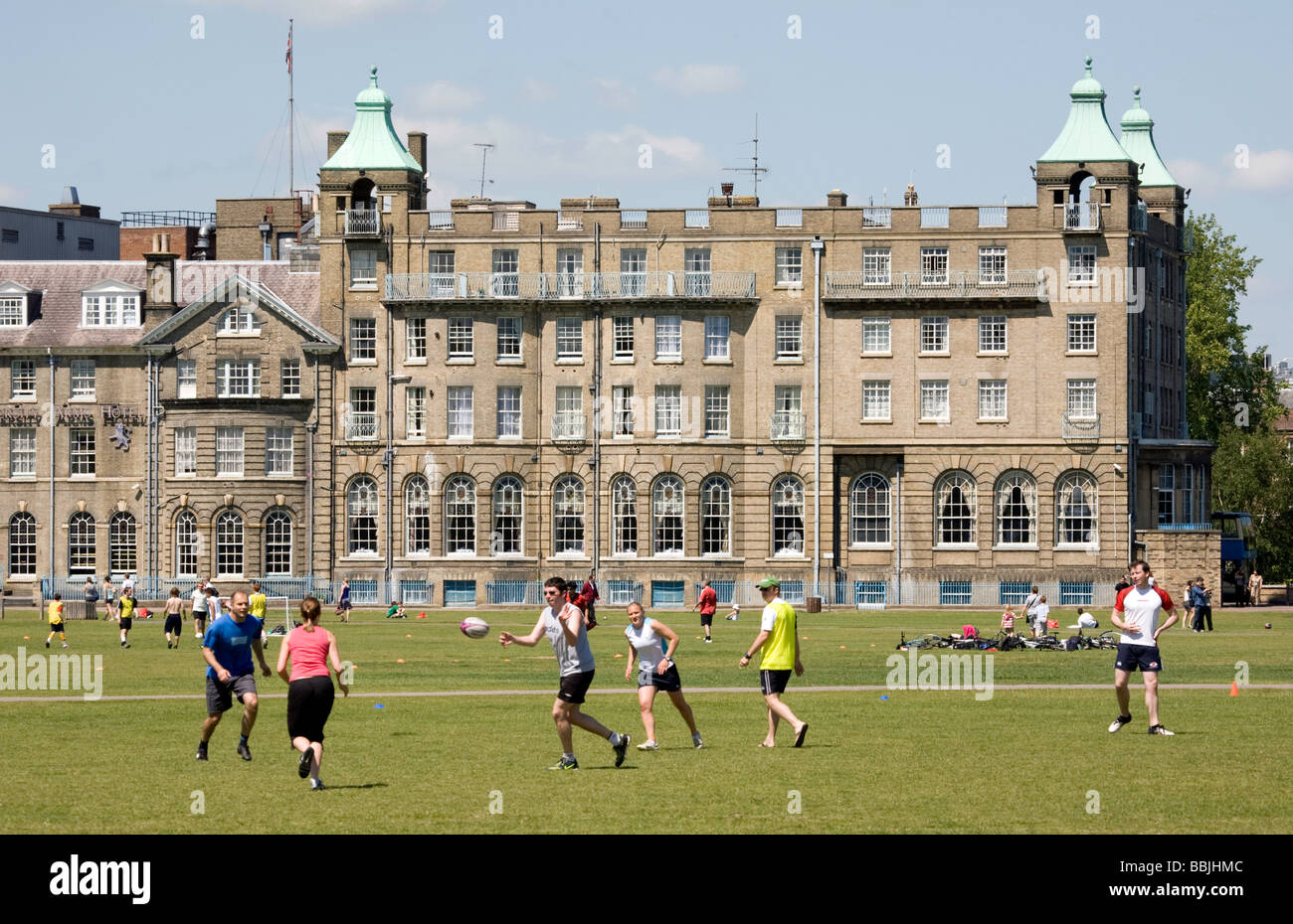 Teenagers playing rugby in front of the University Arms Hotel on Parkers Piece, Cambridge, UK Stock Photo