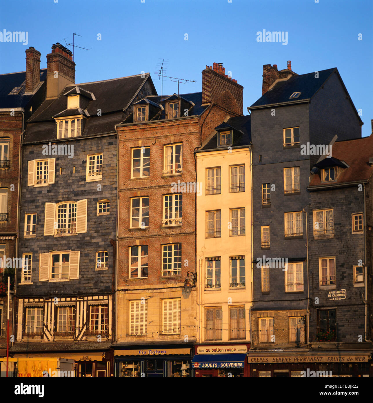 Facades of houses in Honfleur, Normandy, France at dusk Stock Photo