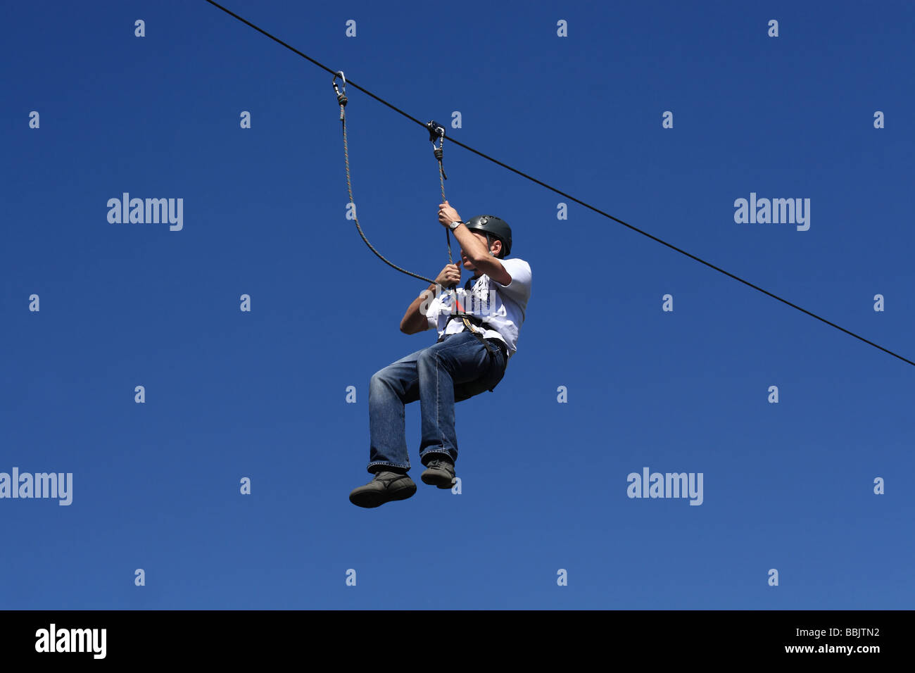Slide down the wire at an adevnture playground Stock Photo Alamy