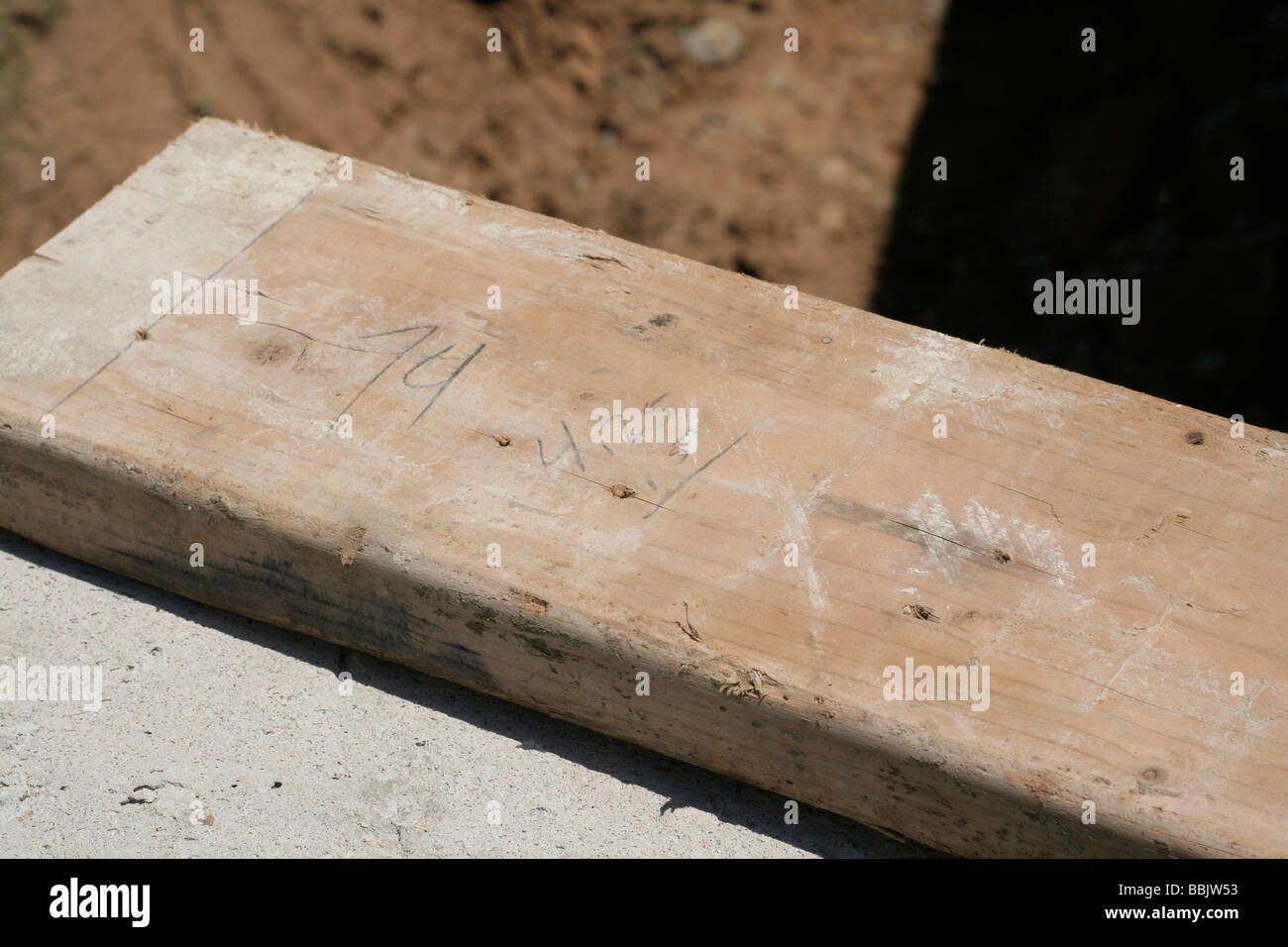 Carpenters arithmetic done on a board at a construction site Stock Photo