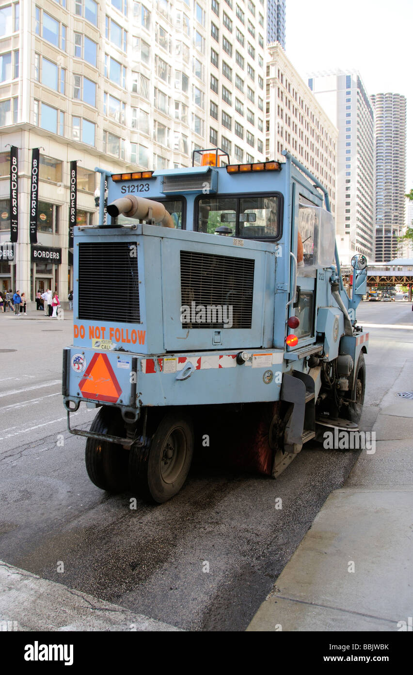 Mechanical road sweeper machine sweeping the gutters of Sate Street