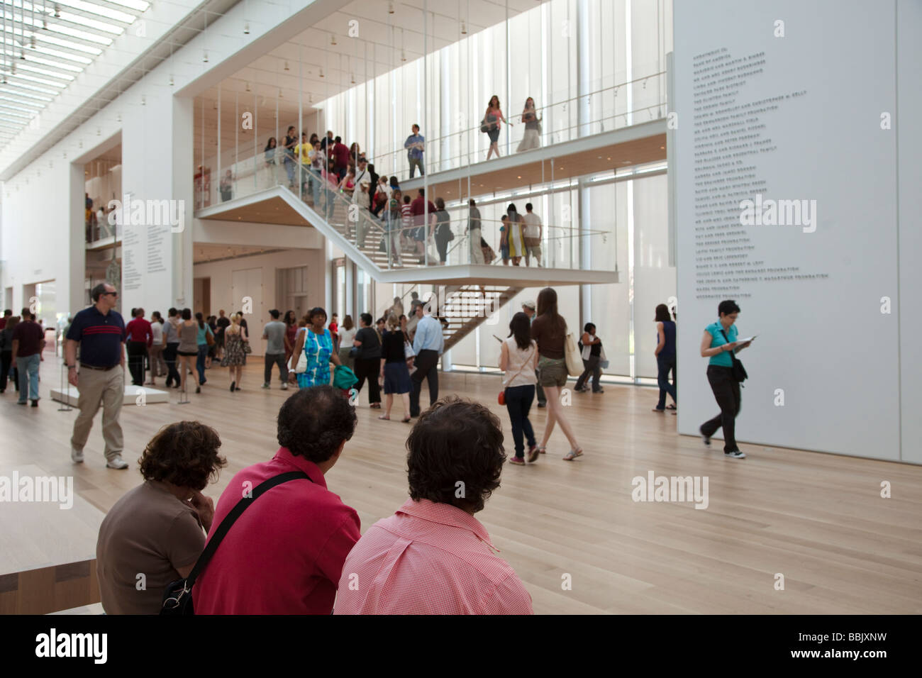 CHICAGO Illinois Visitors sit on benches in Griffin Court lobby of Modern Wing addition to Art Institute museum stairs Stock Photo