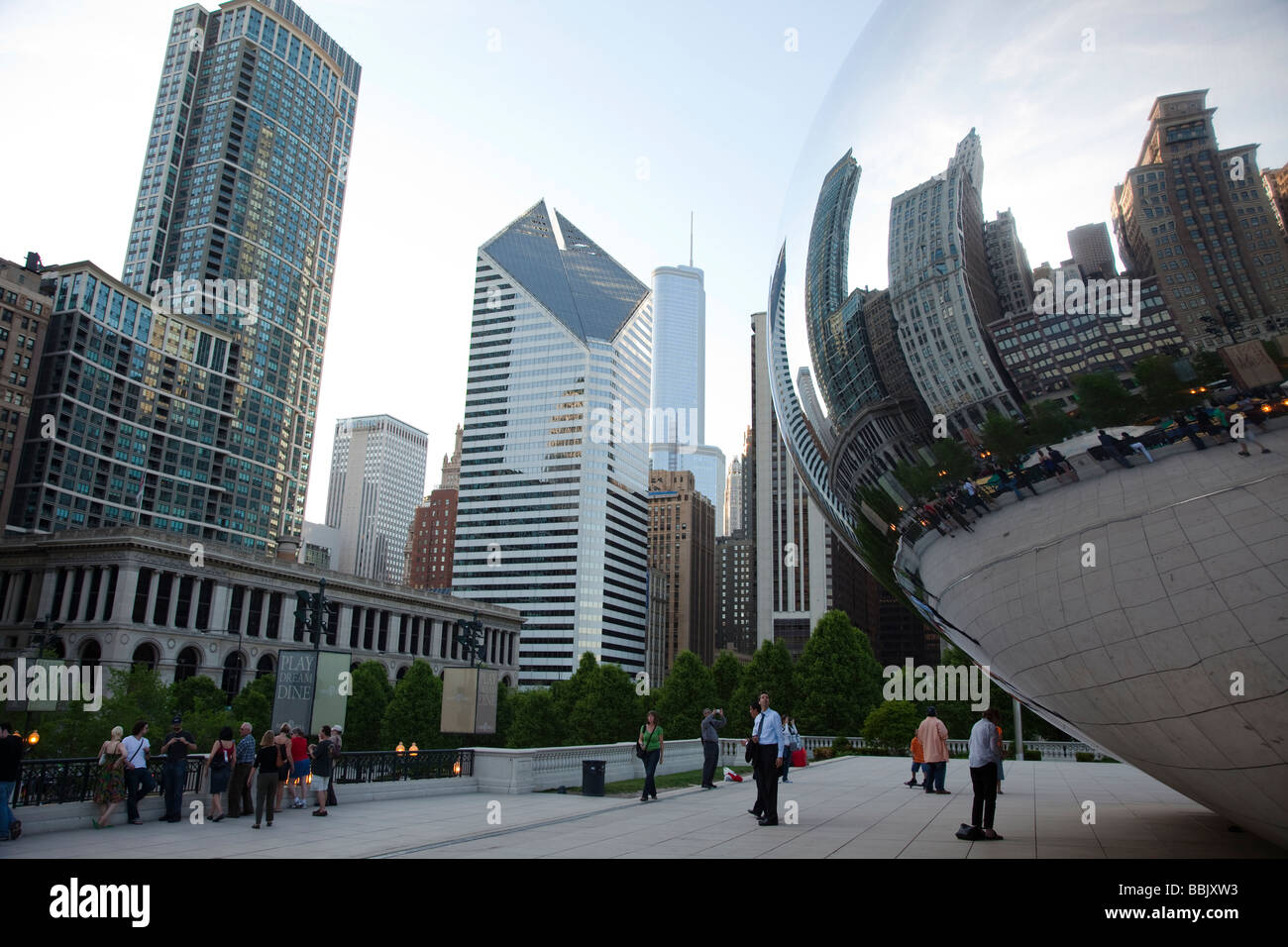 CHICAGO Illinois Bean sculpture in Millennium Park reflecting city skyline visitors enjoying Cloud Gate Stock Photo
