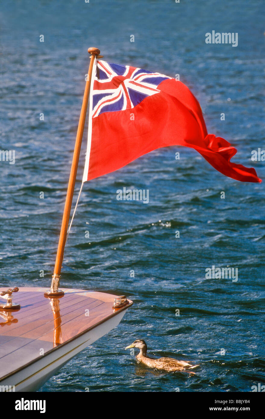The Red Ensign flies on a launch on the River Thames at Henley England