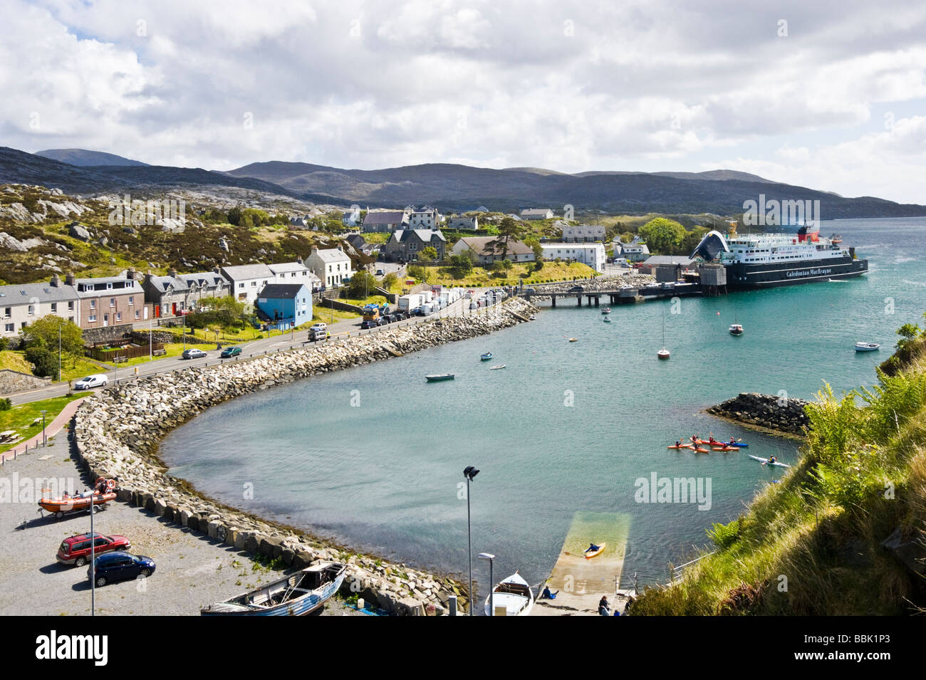 View of the harbour area of Tarbert in Harris Hebrides Scotland with CalMac car ferry Hebrides discharging cars from Uig on Skye Stock Photo