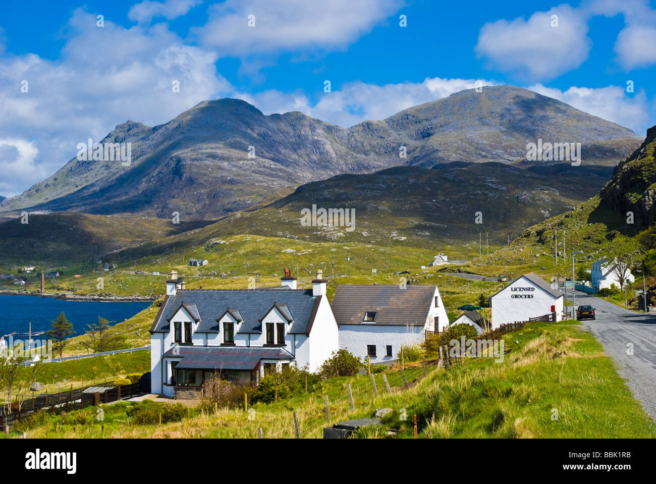 Impressive North Harris mountains behind the small village of Aird Asaig on the A859 connecting Tarbert with Stornoway Stock Photo