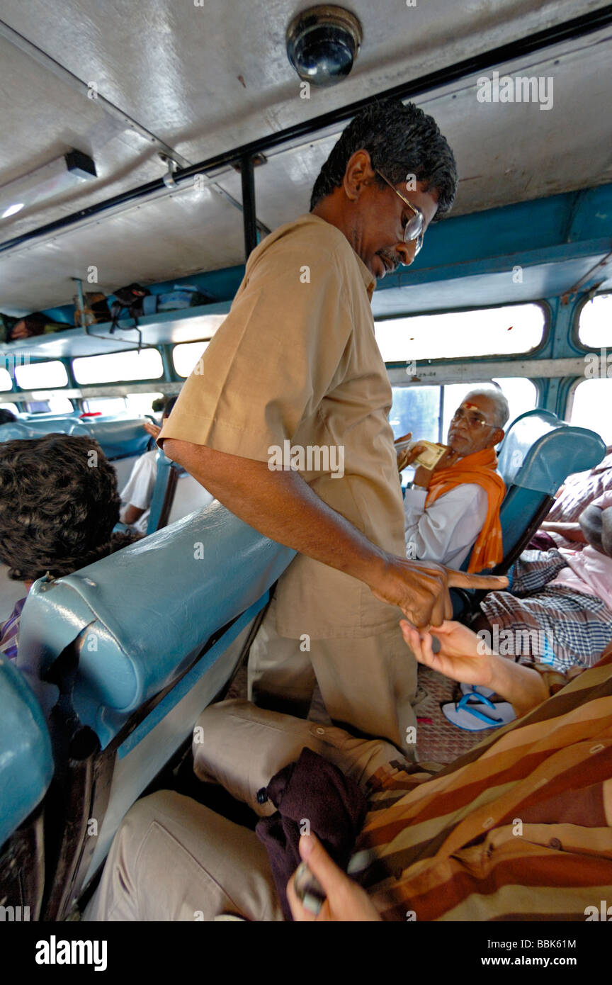 India, Tamil Nadu, Chennai (Madras). Paying the fare on a local bus from Chennai to Pondicherry. No releases available. Stock Photo